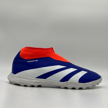 Side view of an adidas Predator League laceless turf soccer boot in lucid blue, footwear white, and solar red with a white lugged rubber outsole.