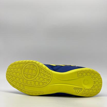 Close-up of a blue and yellow athletic shoe sole on a gray background